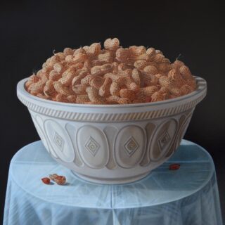 a white bowl full of monkey nuts