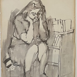 Woman sitting with hands to face